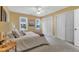 Bright bedroom featuring a queen-size bed, two windows, and a ceiling fan at 4600 Townesbury Ln, Raleigh, NC 27612