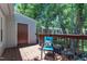 Outdoor deck featuring a blue chair, railings, and an access door to the shed at 4600 Townesbury Ln, Raleigh, NC 27612