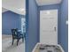 Inviting entryway featuring blue walls, a white front door, and views into the dining area at 4600 Townesbury Ln, Raleigh, NC 27612