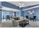 Spacious living room with a comfortable sofa, ceiling fan, and view of the dining area at 4600 Townesbury Ln, Raleigh, NC 27612