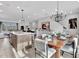 Open-concept dining area showcasing modern lighting, dining table, and seamless flow to the kitchen and living spaces at 5032 Jowetts Walk Dr # 26, Cary, NC 27519