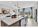 Kitchen island with a quartz countertop, stylish pendant lights, and modern appliances in a well-lit space at 5032 Jowetts Walk Dr # 26, Cary, NC 27519