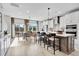 Open-concept kitchen and dining area with modern appliances, island seating, and an inviting dining table at 5032 Jowetts Walk Dr # 26, Cary, NC 27519