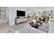 Contemporary living room featuring a modern media center, stylish decor, and an open floor plan at 5032 Jowetts Walk Dr # 26, Cary, NC 27519