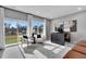 Bright living room featuring neutral walls, modern furniture, and large windows with scenic views at 5032 Jowetts Walk Dr # 26, Cary, NC 27519