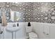 Stylish powder room with black floral wallpaper and a pedestal sink at 5032 Jowetts Walk Dr # 26, Cary, NC 27519