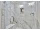 Luxurious shower features white marble tile and a built-in shelf at 5032 Jowetts Walk Dr # 26, Cary, NC 27519