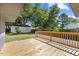 Wooden back deck with railing overlooks the backyard and detached garage space at 506 W Walnut St, Selma, NC 27576