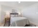 Comfortable bedroom featuring modern lighting, fresh paint, and new flooring at 506 W Walnut St, Selma, NC 27576