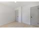 This bedroom has neutral walls, pale wood-look floors, and two closets with modern doors at 506 W Walnut St, Selma, NC 27576