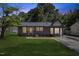Charming single-story home featuring a freshly painted exterior and a well-manicured front lawn at 506 W Walnut St, Selma, NC 27576