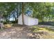 Exterior view of the detached single car garage and gravel driveway at 506 W Walnut St, Selma, NC 27576