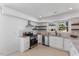 This updated kitchen features granite counters, stainless appliances, and white cabinetry at 506 W Walnut St, Selma, NC 27576