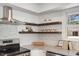 Close-up of the stainless steel range, granite counters, and decorative shelving in this updated kitchen at 506 W Walnut St, Selma, NC 27576