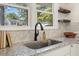 The kitchen boasts granite counters, a stylish sink, and floating wood shelves at 506 W Walnut St, Selma, NC 27576
