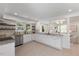 Open kitchen with stainless appliances, granite counters, white cabinets and view to the living room at 506 W Walnut St, Selma, NC 27576