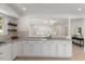Kitchen with granite counters, white cabinets, and open access to the living room at 506 W Walnut St, Selma, NC 27576