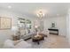 Bright living room features neutral decor, a plush sofa, and an ornate light fixture at 506 W Walnut St, Selma, NC 27576