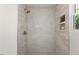 Walk-in shower features tiled walls and brass fixtures at 506 W Walnut St, Selma, NC 27576