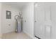 Utility Room featuring a new water heater and laminate flooring at 506 W Walnut St, Selma, NC 27576