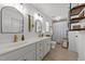 Bright bathroom with double vanity, stylish mirrors, and industrial-style shelving at 509 Par Dr, Nashville, NC 27856