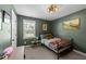 This cozy bedroom includes a dark green accent wall and a brightly-lit window at 509 Par Dr, Nashville, NC 27856