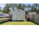 Backyard storage shed, lawnmower and boat parked beside the lawn at 509 Par Dr, Nashville, NC 27856