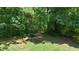 A wooded area in the backyard offers a serene and nature-filled experience at 5320 Middleton Rd, Durham, NC 27713