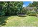 Expansive backyard featuring lush greenery, a trampoline, and an outdoor seating area at 5320 Middleton Rd, Durham, NC 27713