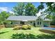 Backyard featuring a wood deck, green lawn, mature trees and a trampoline at 5320 Middleton Rd, Durham, NC 27713