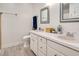 Well-lit bathroom showcasing dual sinks with modern fixtures, wood-look floors, and plenty of counter space at 5320 Middleton Rd, Durham, NC 27713