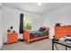 Cozy bedroom with orange furniture, carpet floors, and a window that lets in natural light at 5320 Middleton Rd, Durham, NC 27713