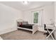 Bright bedroom with carpet, white trim, a bed with plush pillows, and a functional desk area at 5320 Middleton Rd, Durham, NC 27713