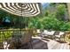 Outdoor living space featuring a striped umbrella, wood decking, and patio furniture at 5320 Middleton Rd, Durham, NC 27713
