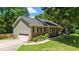 Well-maintained brick home with attached garage, green siding, and neatly landscaped lawn at 5320 Middleton Rd, Durham, NC 27713