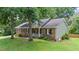 Traditional brick home with sage green siding, black shutters, and a quaint front porch at 5320 Middleton Rd, Durham, NC 27713