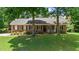 Charming single-story brick home featuring a cozy front porch and well-manicured lawn at 5320 Middleton Rd, Durham, NC 27713
