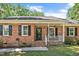 Classic brick home with a cozy front porch and a beautifully landscaped front yard at 5320 Middleton Rd, Durham, NC 27713
