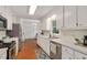 Bright kitchen with stainless steel appliances, ample white cabinetry and a window for natural light at 5320 Middleton Rd, Durham, NC 27713