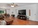 Spacious living room with hardwood floors, a ceiling fan, and an open layout to the dining area at 5320 Middleton Rd, Durham, NC 27713