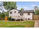 Backyard view showcasing the deck, white siding, shed, and a mix of wood and white vinyl fencing at 5400 Kaplan Dr, Raleigh, NC 27606