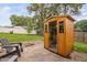 Backyard view featuring wooden sauna, chairs, greenery, and a peaceful ambiance at 5400 Kaplan Dr, Raleigh, NC 27606