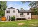 Back exterior featuring a spacious yard, deck, and combination of wooden and white vinyl fencing at 5400 Kaplan Dr, Raleigh, NC 27606