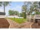 Landscaped backyard featuring a stone pathway, grassy area, and a wooden fence for privacy at 5400 Kaplan Dr, Raleigh, NC 27606