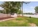 A backyard with a white shed, mulch bed, and a mix of wood and vinyl fencing at 5400 Kaplan Dr, Raleigh, NC 27606