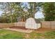 Fenced backyard with a storage shed on a mulch bed, featuring a combination of wood and vinyl fencing at 5400 Kaplan Dr, Raleigh, NC 27606