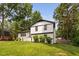 Desirable white brick home, featuring mature trees and lush lawn, on a picturesque street at 5400 Kaplan Dr, Raleigh, NC 27606