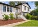 Beautiful white brick house with manicured front yard, featuring brick steps, black railings, and tasteful landscaping at 5400 Kaplan Dr, Raleigh, NC 27606