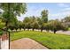 Well-maintained front yard with lush green lawn and mature trees bordering the street, offering a serene view at 5400 Kaplan Dr, Raleigh, NC 27606