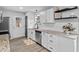 Updated kitchen featuring white cabinets, granite countertops, stainless steel appliances, and modern fixtures at 5400 Kaplan Dr, Raleigh, NC 27606